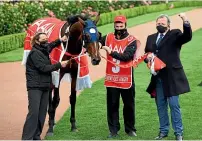  ?? GETTY IMAGES ?? Denis Pagan, right, after winning the Victoria Derby yesterday at Flemington.