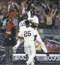  ??  ?? Aaron Hicks ( 31) of the New York Yankees celebrates after hitting a game winning walk- off double in the 11th inning against the Baltimore Orioles at Yankee Stadium on Saturday in New York. The Yankees won 3- 2 and clinced a wild- card playoff berth.