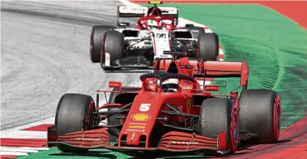  ??  ?? Off the pace: Vettel staying ahead of Alfa Romeo’s Antonio Giovinazzi during the Austrian Grand Prix race. The German finished 10th out of 11 finishers. — AFP