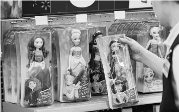  ??  ?? An employee restocks Walt Disney ‘Frozen’ brand toys at a Wal-Mart in Burbank, California, on Nov 22.