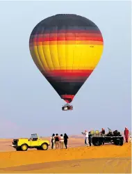  ??  ?? ONLY WAY IS UP: Balloon and vintage Land Rover safari