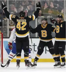  ?? AP ?? PASSING IT AROUND: Forwards Jake DeBrusk (center) and David Krejci (right) celebrate David Backes’ goal in the third period of the 3-1 win over Montreal last night.