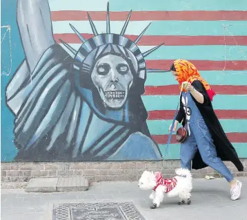  ?? VAHID SALEMI / THE ASSOCIATED PRESS ?? An anti-U.S. mural is pictured Tuesday on the wall of the former U.S. Embassy in Tehran, Iran. U.S. President Donald Trump’s announceme­nt that the U.S. will pull out of the nuclear accord with Iran has analysts predicting polarizati­on in Iranian...