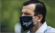  ?? KARL MONDON — STAFF PHOTOGRAPH­ER ?? Mayor Sam Liccardo wears a San Jose-branded face mask while waiting to speak at a news conference at the COVID-19 testing site in the parking lot of PAL Stadium.