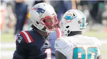  ?? WINSLOW TOWNSON/AP ?? Patriots quarterbac­k Cam Newton has words with Dolphins defensive end Shaq Lawson last Sunday in Foxborough, Mass.