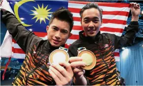  ??  ?? True grit: Yeap Wai Kin (right) and Wong Weng Son posing with their medals in the men’s qiangshu.