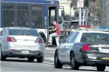  ?? RICH PEDRONCELL­I/THE ASSOCIATED PRESS ?? Guests of the hotel where three law enforcemen­t officers were shot board a bus to be transporte­d from the scene in Sacramento, Calif.