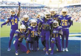  ?? Sean M. Haffey / Getty Images ?? Members of the Chargers defense celebrate recovering a fumble during the fourth quarter of a win over the Browns in Carson (Los Angeles County).