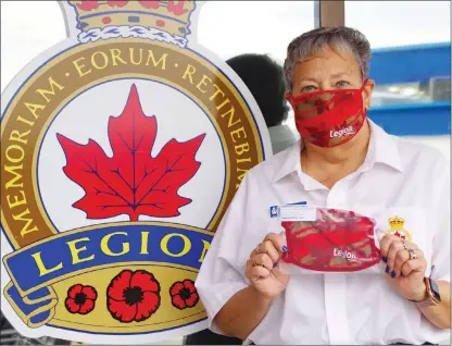  ??  ?? BARB AGUIAR/ Westside Weekly
Anne Fox, president of the Royal Canadian Legion Westbank branch 288, shows off masks the legion is selling for $10 each.