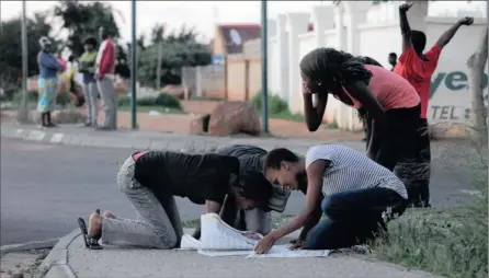  ?? PICTURES: DUMISANI DUBE ?? THE NAME GAME: Matriculan­ts in Meadowland­s, Soweto, eagerly check the paper for their results early yesterday.