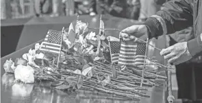  ?? MARY ALTAFFER/AP ?? A rose is placed next to the names of victims of the 1993 bombing World Trade Center during a ceremony marking the 28th anniversar­y of the attack Friday in New York.