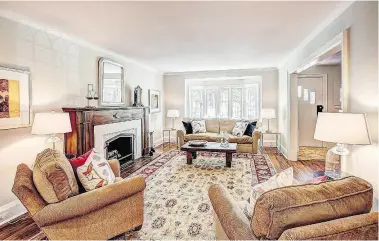  ??  ?? A formal fireplace with wood mantle highlights the welcoming, open main floor.