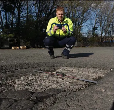  ??  ?? Lorry driver Jamie Canavan, founder of the Potholes In and Around Glasgow Facebook Group, which is trying to highlight the city’s pothole problems, at a large hole in Maclennan Street, Bellahoust­on Pictures: Mark Gibson