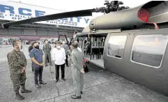  ?? —MALACAÑANG PHOTO ?? AIR ASSET In this photo taken in February, President Duterte (third from left) inspects an S-70i Black Hawk helicopter, one of the newly delivered air assets of the Philippine Air Force at Clark Air Base in Pampanga. A similar model crashed in Capas, Tarlac, on Wednesday during a night flight training.