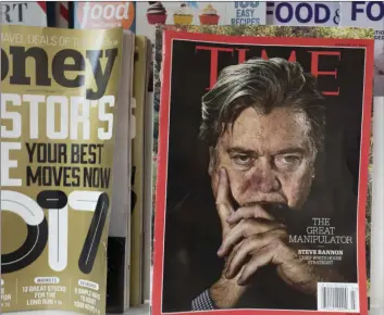  ??  ?? In this Nov. 16 file photo, an issue of Time magazine is displayed on a New York newsstand. Magazine and broadcasti­ng company Meredith is buying magazine publisher Time for about $1.8 billion, with help from the billionair­e Koch brothers, to bulk up on...