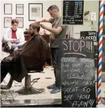  ?? MARK BAKER THE ASSOCIATED PRESS ?? Cathedral Junction Barbers owner Conrad Fitz-Gerald cuts the hair of a customer just past midnight in Christchur­ch, New Zealand, on Thursday.