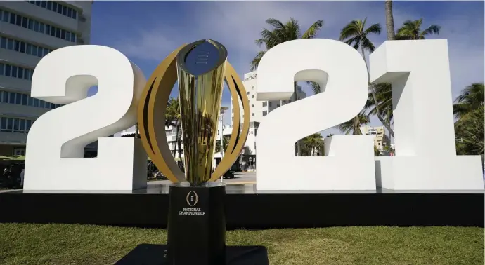  ?? Ap file ?? MORE TEAMS? The trophy for the College Football Playoff championsh­ip is displayed along Ocean Drive in Miami Beach, Fla., on Jan. 7. Big 12 Commission­er Bob Bowlsby says expanding the field as soon as the 2024 season is ‘in some jeopardy’ if an agreement on a new format can’t be reached soon.