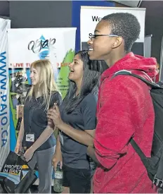  ?? POSTMEDIA NETWORK FILE ?? Assumption College students Izzy White, Teena Bhagat, and Justus Alexander attend the Epic Jobs job fair at Galaxy Cinemas in Brantford, Ont., earlier this month.