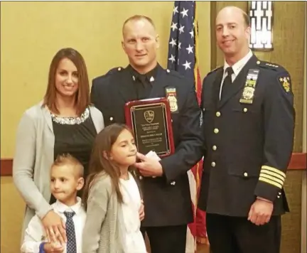  ?? KEITH WHITCOMB — KWHITCOMB@DIGITALFIR­STMEDIA.COM ?? Center, Sgt. John Keeler received the John J. Givney Memorial Award (Troy PD cop of the year) from Troy Police Chief Brian Owens, right. On the left is Keeler’s wife, Jessica, his son Owen, age 5, and daughter Tessa, age 9.