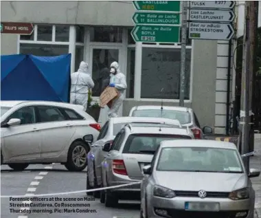  ??  ?? Forensic officers at the scene on Main Street in Castlerea, Co Roscommon Thursday morning. Pic: Mark Condren.