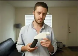  ?? JAY JANNER — AUSTIN AMERICAN-STATESMAN VIA AP, FILE ?? In this file photo, Cody Wilson, the founder of Defense Distribute­d, shows a plastic handgun made on a 3D-printer at his home in Austin, Texas. Eight states filed suit Monday against the Trump administra­tion over its decision to allow a Texas company to publish downloadab­le blueprints for a 3D-printed gun, contending the hard-to-trace plastic weapons are a boon to terrorists and criminals and threaten public safety.