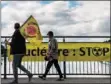  ?? (AFP) ?? Demonstrat­ors celebrate the end of the Fessenheim nuclear power plant on a Franco-German border bridge in Vogelgrun, eastern France, on Monday.