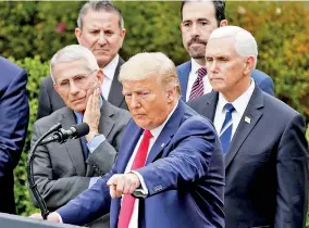  ??  ?? US President Donald Trump at a news conference where he declared the coronaviru­s pandemic a national emergency. National Institute of Allergy and Infectious Diseases Director Anthony Fauci (L) looks on. (REUTERS)