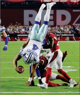  ?? ASSOCIATED PRESS ?? DALLAS COWBOYS QUARTERBAC­K DAK PRESCOTT (4) dives for a touchdown as Arizona Cardinals cornerback Justin Bethel (28) and strong safety Antoine Bethea (rear) defend during the first half Monday in Glendale.