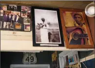  ?? (AP/Rogelio V. Solis) ?? Portraits of Henry Stuckey, the originator of the Bentonia Bblues (second from right) and area resident and bluesman Jack Owens, hang high on the wall at the Blue Front Cafe in Bentonia, Miss. Blues performer Jimmy “Duck” Holmes credits Stuckey and Owens for having influenced his adoption of the Bentonia style of blues playing.