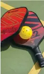  ?? ?? Pickleball racquets and ball.