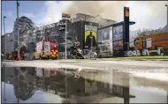  ?? (AP/Ritzau Scanpix/Mads Claus Rasmussen) ?? Firefighte­rs work on a fire that broke out at the Stock Exchange in Copenhagen, on Tuesday.