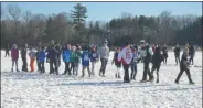  ??  ?? Players shake hands after a game of football on Christmas Eve morning at the fourth annual Christmas Eve Bowl at Gavin Park in Wilton.