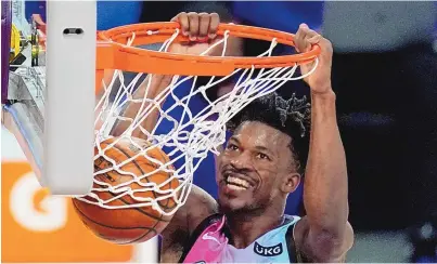  ?? MARK J. TERRILL/ASSOCIATED PRESS ?? Miami’s Jimmy Butler dunks in the second half for two of his 24 points a two-point victory against the host Los Angeles Lakers on Saturday night.