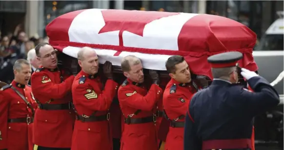  ?? CARLOS OSORIO/TORONTO STAR ?? Pallbearer­s carry the body of Jim Flaherty into St. James Cathedral during his state funeral. “He could be hard-headed, yet also soft-hearted,” Prime Minister Stephen Harper said.