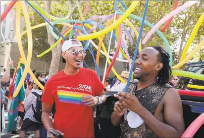  ?? PHOTOS BY JIM GENSHEIMER — STAFF PHOTOGRAPH­ER ?? Kamryn Duque, at left, and Edward Clark, both of San Jose, wait for the parade start with the Silicon Valley Gay Men’s Chorus during the Silicon Valley Pride parade on Sunday in San Jose.