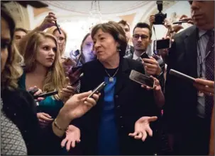  ?? The Associated Press ?? HEALTH BILL: Sen. Susan Collins, R-Maine is surrounded by reporters Thursday on Capitol Hill in Washington after a revised version of the Republican health care bill was announced by Senate Majority Leader Mitch McConnell of Ky. The bill has faced...