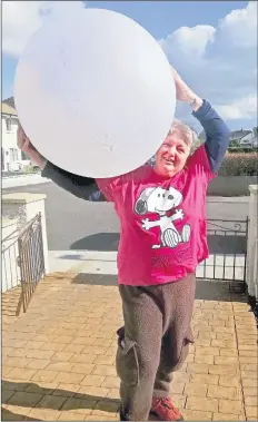  ?? (Photo: John O’Connell) ?? RIGHT: GOING GLOBAL - Anna O’Connor of Fermoy Street Arts pictured recently holding up the world, as the group get going on yet another project.