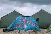  ?? Philippe Huguen AFP/Getty Images ?? A TENT painted with the British f lag. Thousands of migrants in the camp are desperate to reach Britain.