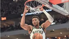  ?? BENNY SIEU/USA TODAY SPORTS ?? Bucks forward Giannis Antetokoun­mpo throws down a dunk against the Raptors.