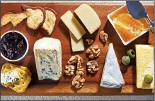  ?? For The Washington Post/STACY ZARIN GOLDBERG ?? On this board, clockwise from top left: dried pears, havarti, honey with honeycomb, English cheddar, olives, Camembert, walnuts, creamy blue, crackers and currant jam.