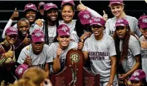 ?? Sam Craft / Associated Press ?? The Texas A&M women’s basketball team poses with the Southeaste­rn Conference regular-season trophy. It was the Aggies’ first conference title since winning the Big 12 in 2007.
