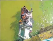  ?? AFP ?? People rescuing passengers after a mini bus ferrying a wedding party fell into a river in Rajasthan while crossing a bridge.