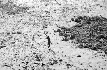  ??  ?? File photo shows a man with the Sentineles­e tribe aims his bow and arrow at an Indian Coast Guard helicopter as it flies over North Sentinel Island in the Andaman Islands, in the wake of the 2004 Indian Ocean tsunami. — AFP photo