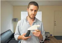  ?? Jay Janner / Austin American-Statesman ?? Cody Wilson displays the first completely 3D-printed handgun, the Liberator, at his home in Austin, in 2013.