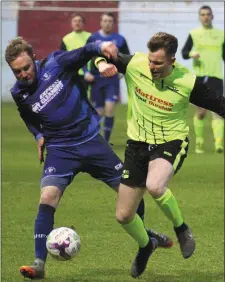  ??  ?? Kevin Walsh of Boyne Harps is challenged by Muirhevnam­or’s Paul Mallon.