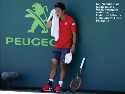  ??  ?? Kei Nishikori, of Japan, takes a break during his match against Federico Delbonis at the Miami Open Photo: AP