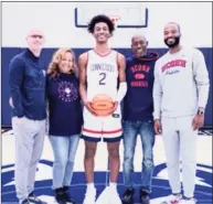  ?? Contribute­d photo ?? During his recruiting visit to UConn, Stephon Castle, a 6-foot-6 guard from Georgia, posed with, from left, UConn coach Dan Hurley, Castle’s mother, Quannette, his father, Stacey, and UConn associate head coach Kimani Young.