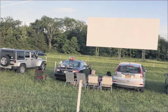  ?? Photos by Amy Biancolli / times union ?? the grounds at the Greenville drive-in open two hours before show time and people come early to picnic and visit before the movie starts. the Greenville, a participan­t in the state’s taste ny program, offers locally sourced food and drinks at the concession.