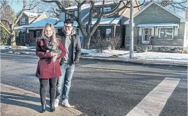  ?? ANDREW FRANCIS WALLACE TORONTO STAR FILE PHOTO ?? Stephanie Chouinard and her husband, Sean, pose with their schnauzer outside their Toronto home in December. The couple pulled enough money out of their investment­s for a down payment before the market crashed.