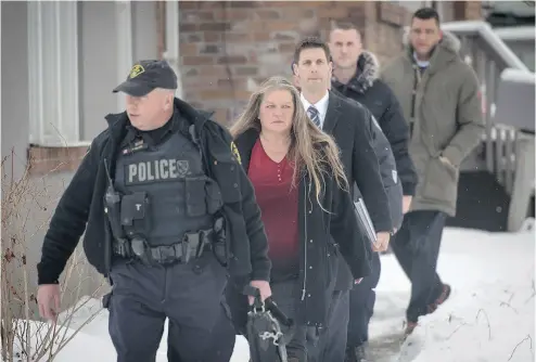  ?? TYLER ANDERSON / NATIONAL POST ?? Investigat­ors, including forensic anthropolo­gist Kathy Gruspier, leave the backyard of a Mallory Crescent home in Toronto Thursday where accused serial killer Bruce McArthur worked as a landscaper.